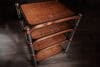 Richly grained wooden shelving unit with metal frame, modern furniture design.