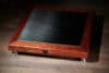 Sophisticated wooden hi-fi speaker with metal grille, designed for high-quality audio.