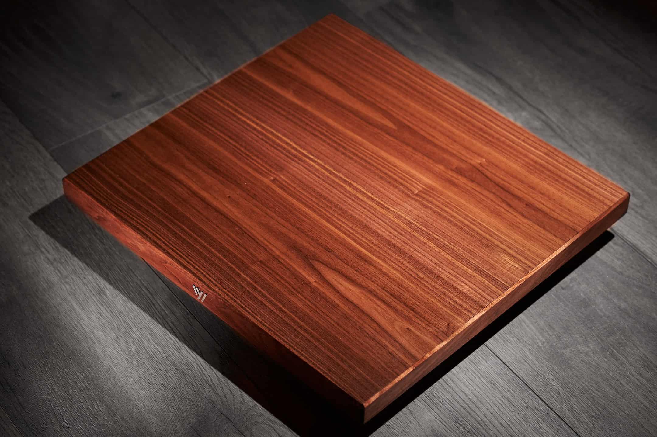 Elegant wooden hardwood flooring sample on dark wood surface.