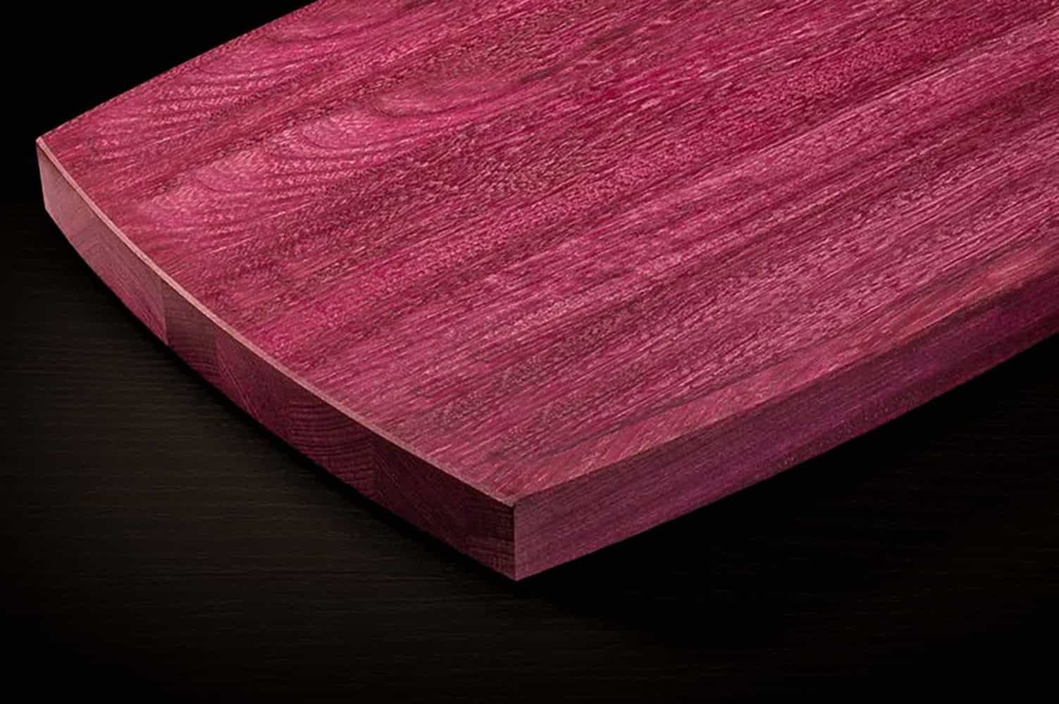 Glossy pink stained wood plank showcasing quality woodworking and craftsmanship.